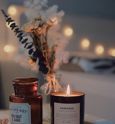 a candle and a jar on a table