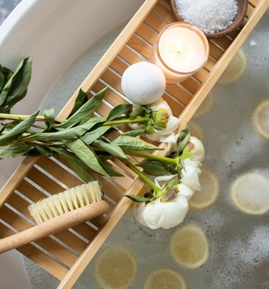 a bathtub with a bathtub full of lemons and flowers