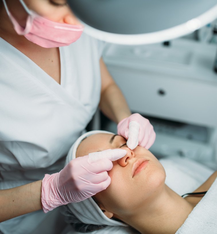 a woman getting a facial treatment